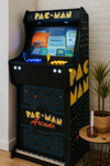arcade machine pac man met logo arcade kast, verlicht bedieningspaneel en een scherm met een klassiek spelmenu.