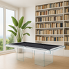 Design pooltafel met glazen onderstel en zwart speelveld, geplaatst in een luxe, lichte ruimte met boekenkasten, kamerplanten en uitzicht op groene natuur.