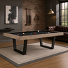 Moderne pooltafel met zwart speelvlak en licht houten frame in een stijlvolle mancave met bakstenen muur, leren Chesterfield-bank, houten vloer en industriële accenten.